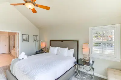 a bedroom with a white bed and a window at Lake Arrowhead Home Mountain View, Walk to Water! in Lake Arrowhead