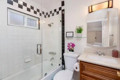 a bathroom with a toilet and a sink and a shower at Central LA Bliss: 5 BR Home, BBQ, Perfect Location in Los Angeles