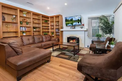 a living room with a couch and a fireplace at Central LA Bliss: 5 BR Home, BBQ, Perfect Location in Los Angeles
