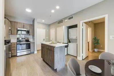 a large kitchen with white appliances and a table at Woodland Hills Luxury Apt 2 bed CA in Los Angeles