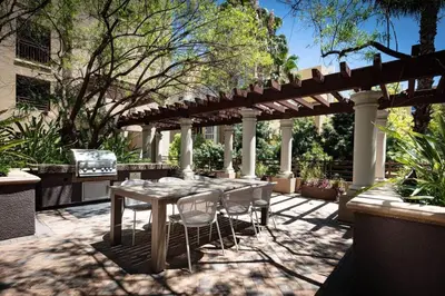 a patio with a table and chairs under a pergola at Woodland Hills Luxury Apt 2 bed CA in Los Angeles