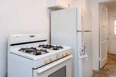 a white stove in a kitchen next to a refrigerator at Luxe 1-bedroom Gem: Venice Beach Escape in Los Angeles