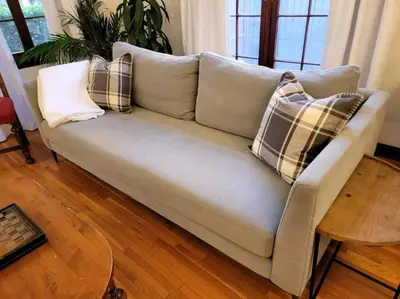 a couch with pillows on it in a living room at Glamorous Getaway: Exclusive 1BR LA Hotspots in Los Angeles
