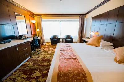 a hotel room with a large bed and a television at LA Crystal Hotel -Los Angeles-Long Beach Area in Carson