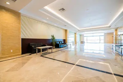 a lobby with a table and chairs in a building at LA Crystal Hotel -Los Angeles-Long Beach Area in Carson