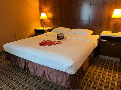 a hotel room with a large bed with red roses on it at LA Crystal Hotel -Los Angeles-Long Beach Area in Carson