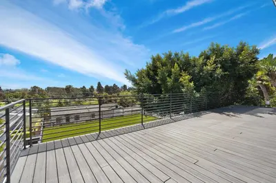 a wooden deck with a fence and a bench at Stunning Modern 5BR Family Mansion, Panoramic views of Penmar Golf, Pet Friendly! in Los Angeles