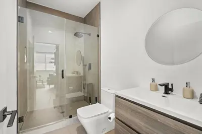 a bathroom with a shower and a toilet and a sink at Private Cozy Guest House, King Bed, Parking, Pet Friendly near Penmar Golf Course! in Los Angeles