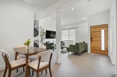 a dining room and living room with a table and chairs at Private Cozy Guest House, King Bed, Parking, Pet Friendly near Penmar Golf Course! in Los Angeles