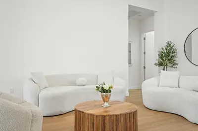 a living room with two couches and a table with flowers at New Lavish Elegant 3BR Home in Mar Vista, Pet Friendly! 10min to Venice Beach! in Los Angeles