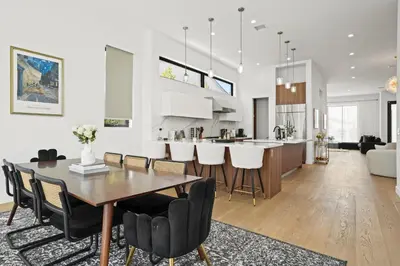 a dining room and kitchen with a table and chairs at New Lavish Elegant 3BR Home in Mar Vista, Pet Friendly! 10min to Venice Beach! in Los Angeles