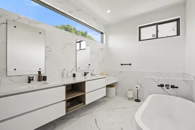 a white bathroom with a tub and a sink at New Lavish Elegant 3BR Home in Mar Vista, Pet Friendly! 10min to Venice Beach! in Los Angeles