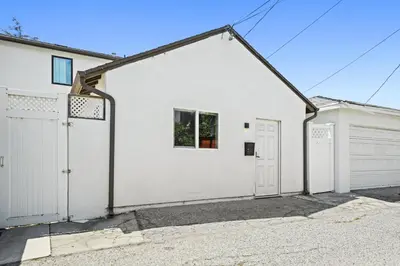 a white house with a garage at New Modern Cozy Guest House, Parking, Pet Friendly in Mar Vista! in Los Angeles