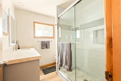a bathroom with a glass shower and a sink at Lakeside Paradise Escape in Big Bear Lake
