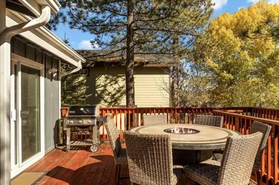 a patio with a table and chairs and a grill at Lakeside Paradise Escape in Big Bear Lake