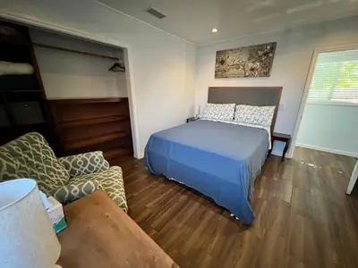 a bedroom with a bed and a couch and a table at An Amazing comfortable home front middle unit 1q bed and other room with sofa in Los Angeles
