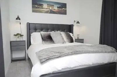 a bedroom with a large bed with white sheets and pillows at 2 Miles to Disneyland -FREE Parking! In Anaheim CA in Anaheim