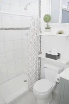 a white bathroom with a toilet and a shower at 2 Miles to Disneyland -FREE Parking! In Anaheim CA in Anaheim