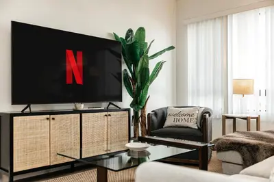 a living room with a tv on top of a cabinet at Central Quality 2 BD Apartment in Los Angeles