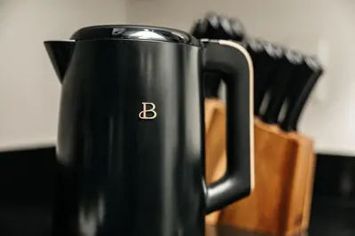 a black coffee pot sitting on a table with knives at Central Quality 2 BD Apartment in Los Angeles