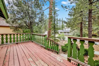 a wooden deck with a fence and trees at Pines and needles #1454 in Big Bear Lake