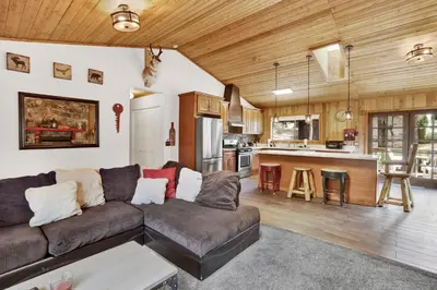 a living room with a couch and a kitchen at Pines and needles #1454 in Big Bear Lake