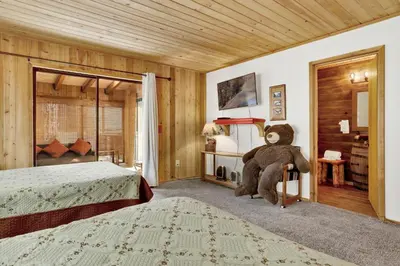 a bedroom with a large teddy bear sitting in a chair at Pines and needles #1454 in Big Bear Lake
