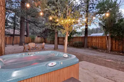 a jacuzzi tub in a yard with a bench at Cozy fox #2035 in Big Bear Lake