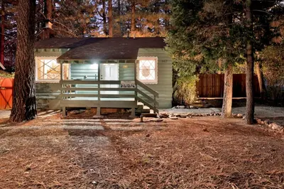 a tiny house with a porch in the woods at Cozy fox #2035 in Big Bear Lake