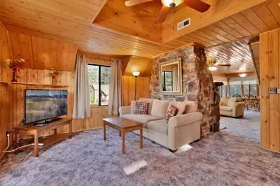 a living room with a couch and a tv at Pine nest#2296 in Big Bear Lake