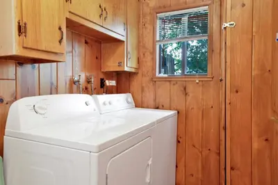 a white washer and dryer in a wooden laundry room at Pine nest#2296 in Big Bear Lake