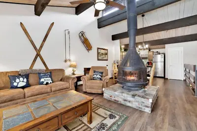 a living room with a large fireplace in the center at Smith summit chalet #2461 in Big Bear Lake