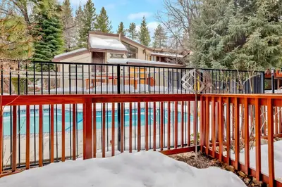 a fence with a pool in front of a house at Smith summit chalet #2461 in Big Bear Lake