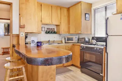 a kitchen with wooden cabinets and a wooden counter top at JUS' RESTIN #265 in Big Bear Lake