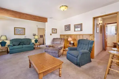 a living room with two blue chairs and a table at JUS' RESTIN #265 in Big Bear Lake