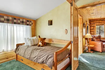 a dog sitting on a bed in a bedroom at Pleasant Pause#1864 in Fawnskin