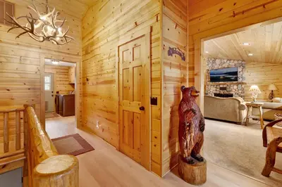 a log cabin with a bear statue in a room at All about fun #1149 in Big Bear Lake