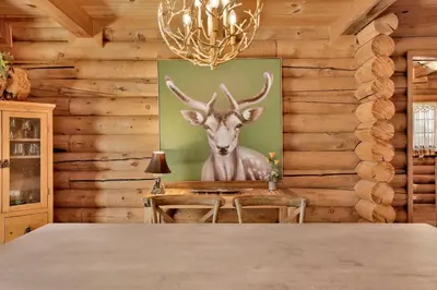 a painting of a deer on a wall in a dining room at Woodland log #1887 in Big Bear Lake
