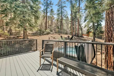 a deck with a bench and a view of a pond at Woodland log #1887 in Big Bear Lake