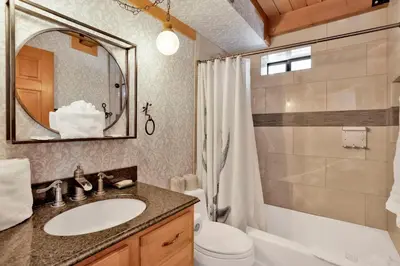 a bathroom with a sink and a toilet and a mirror at Woodland log #1887 in Big Bear Lake