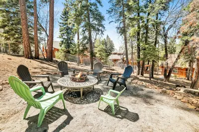 a group of chairs and a table with a fire pit at Woodland log #1887 in Big Bear Lake