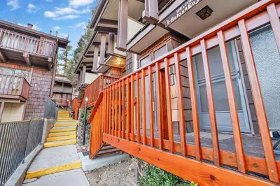 a house with a wooden fence on the side of it at Chairlift lodge#2354 in Big Bear Lake