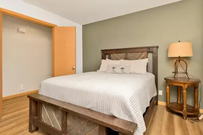a bedroom with a bed with a wooden headboard at CAN'T BEAR TO LEAVE #1156 in Big Bear Lake