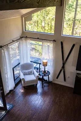 a living room with a chair and a large window at Soaring pines #2193 in Big Bear Lake