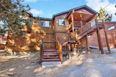 a log home with stairs leading up to it at River rock lodge #1953 in Big Bear Lake