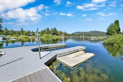 a dock on a lake with boats in the water at Breezy one #112 in Big Bear Lake