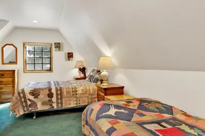 a bedroom with two beds and a window at Breezy one #112 in Big Bear Lake