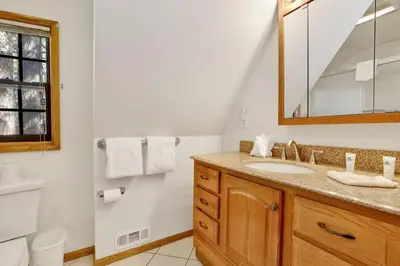 a bathroom with a sink and a mirror at Breezy one #112 in Big Bear Lake