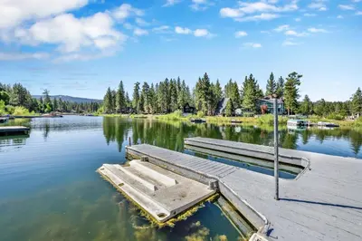 a dock with two benches on a lake at Breezy one #112 in Big Bear Lake