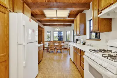 a kitchen with white appliances and a dining room at Breezy one #112 in Big Bear Lake